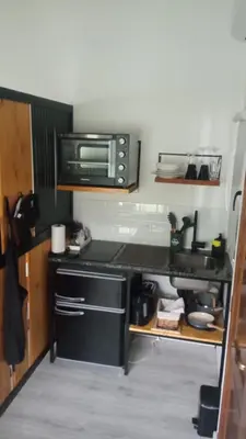 a kitchen with a stove and a microwave at Departamento Zona Norte, Kempes, Allende Cerro in Cordoba