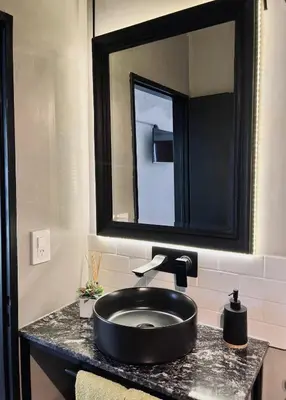 a bathroom with a black sink and a mirror at Departamento Zona Norte, Kempes, Allende Cerro in Cordoba