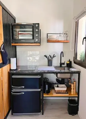 a kitchen with a sink and a microwave at Departamento Zona Norte, Kempes, Allende Cerro in Cordoba