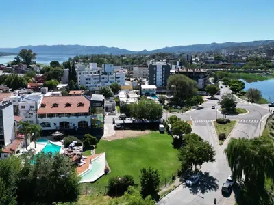an aerial view of a city with a park at Hotel El Condado in Villa Carlos Paz