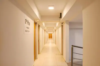 a long hallway with white walls and a long hallway at Hotel El Condado in Villa Carlos Paz