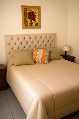 a bedroom with a large bed with a large headboard at Departamento 