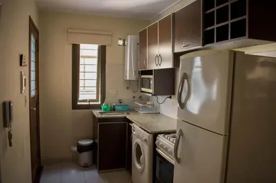 a kitchen with a refrigerator and a washer and dryer at Departamento 