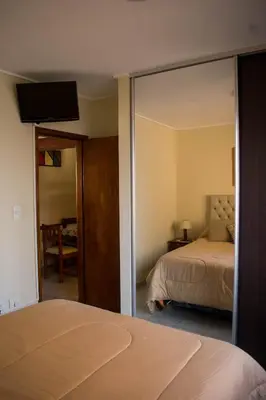 a bedroom with a bed and a large mirror at Departamento 