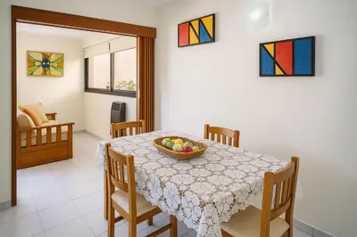 a dining room with a table with a bowl of fruit on it at Departamento 