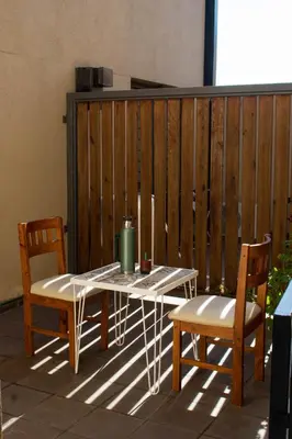a table and two chairs on a patio at Departamento 