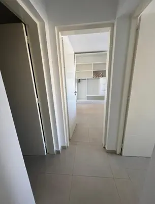a hallway with an open door to a kitchen at Casaabril in Villa Carlos Paz
