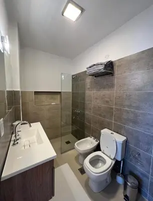 a bathroom with a toilet and a sink and a shower at Casaabril in Villa Carlos Paz