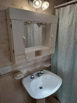 a bathroom with a white sink and a mirror at La Mora Casa in Mina Clavero
