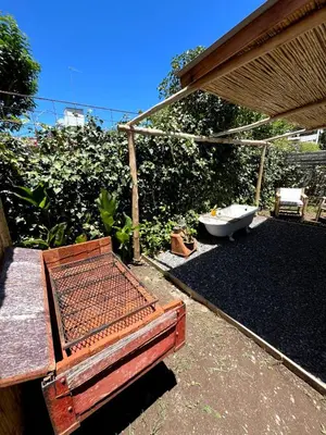 a bath tub sitting in a yard with at CASITA PINTORESCA EN LAS SIERRAS Y LAGO in San Roque