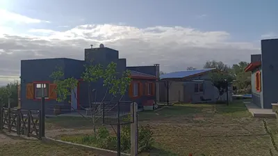 a group of houses in a yard with a fence at EL RANCHO DE PIA in Merlo