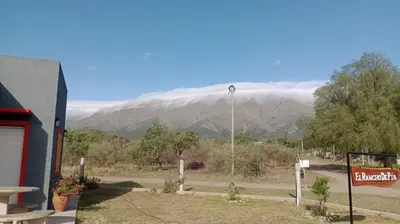 a view of a mountain range with clouds in the background at EL RANCHO DE PIA in Merlo