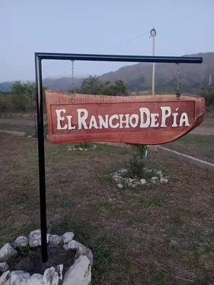 a sign that reads el rancho pta in a field at EL RANCHO DE PIA in Merlo