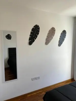 a wall with three leaf decals on a wall at Viaggiato Catamarca in Cordoba