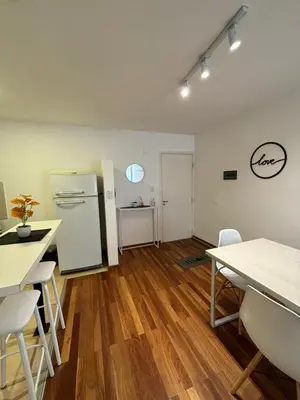 a kitchen with a refrigerator and a table and chairs at Viaggiato Catamarca in Cordoba