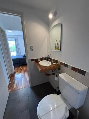 a bathroom with a white toilet and a sink at Viaggiato Catamarca in Cordoba