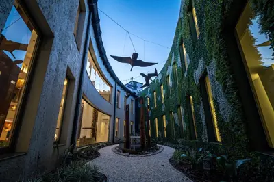 a hallway of a building with a bird hanging from the ceiling at Domingo Design Hotel in Santa Rosa de Calamuchita