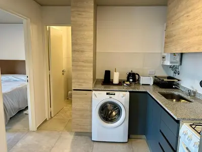 a kitchen with a washing machine and a sink at Rent a Flat Nueva Cordoba in Cordoba