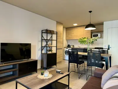 a living room with a couch and a table with chairs at Rent a Flat Nueva Cordoba in Cordoba