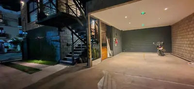 a building with a motorcycle parked inside of it at Vivisierras, Piso 4 frente al lago Centro Villa Carlos Paz, pileta privada, vista panorámica in Villa Carlos Paz
