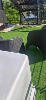 a table and chairs on a field of grass at Vivisierras, Piso 4 frente al lago Centro Villa Carlos Paz, pileta privada, vista panorámica in Villa Carlos Paz