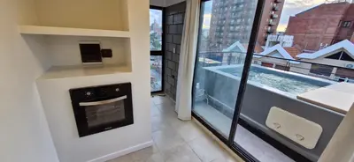 a living room with a fireplace and a view of a city at Vivisierras, Piso 3 frente al lago, centro Villa Carlos Paz, 2 dormitorios, 2 baños, pileta privada, premium in Villa Carlos Paz