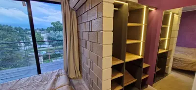 a room with a brick wall and a window at Vivisierras, Piso 3 frente al lago, centro Villa Carlos Paz, 2 dormitorios, 2 baños, pileta privada, premium in Villa Carlos Paz