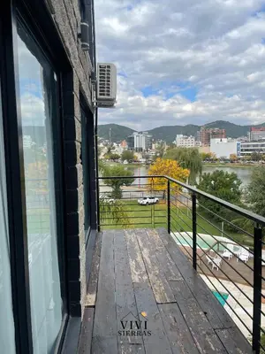 a balcony with a view of a river and a city at Vivisierras, Piso 3 frente al lago, centro Villa Carlos Paz, 2 dormitorios, 2 baños, pileta privada, premium in Villa Carlos Paz