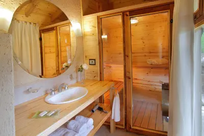 a bathroom with a sink in a wooden cabin at Cabañas Sierra Serena in Villa General Belgrano