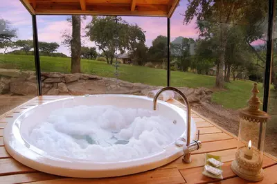 a bath tub sitting on top of a wooden deck at Cabañas Sierra Serena in Villa General Belgrano