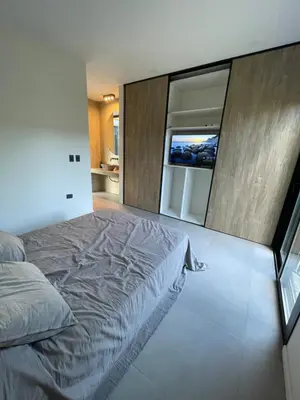 a bedroom with a large bed and a large mirror at RumaRanch Solo Parejas Casa con pileta privada a 20 mts del Río in Villa Carlos Paz