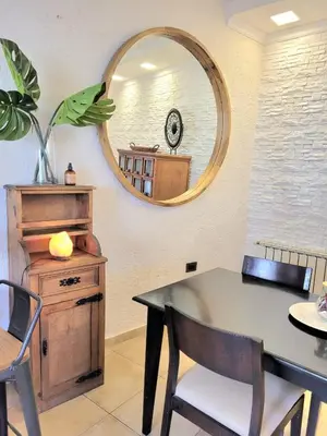 a dining room with a table and a mirror at Córdoba Rent Apart - Mona Suites in Cordoba