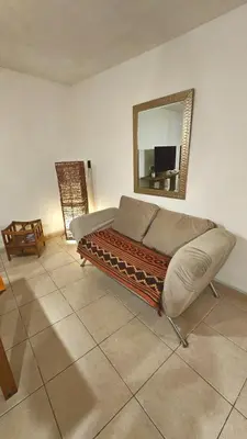a bedroom with a bed and a mirror on the wall at Córdoba Rent Apart - Mona Suites in Cordoba