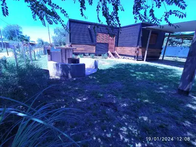 a yard with a house in the background at La Cautiva 225 in Villa del Dique