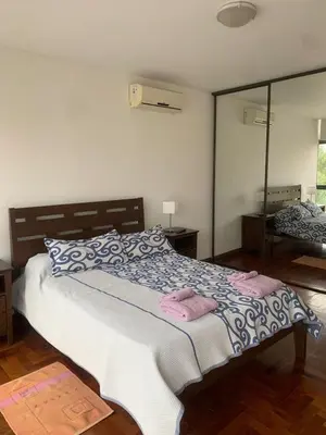 a bedroom with a bed with two pink towels on it at Departamento boutiques, centrico in Villa Carlos Paz