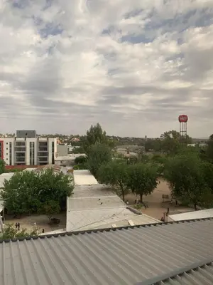 a view of a city with a water tower and trees at Departamento boutiques, centrico in Villa Carlos Paz
