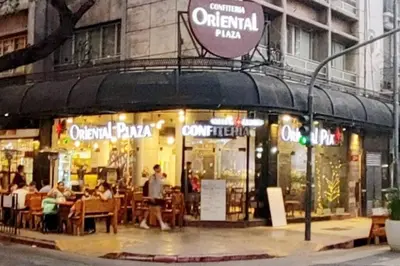 a restaurant with people sitting outside of it on a city street at Miniapartamento Ames pleno centro, duermen 4 in Cordoba
