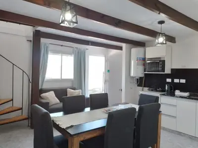 a kitchen and dining room with a table and chairs at Complejo El Bonsai in Villa Santa Cruz del Lago