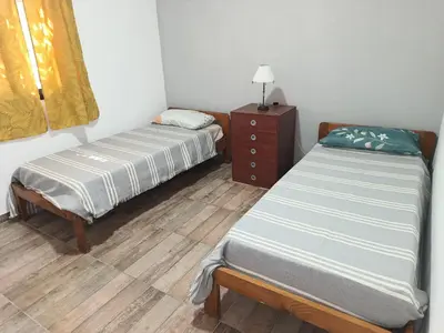 a room with two beds and a dresser and a bed sidx sidx sidx sidx at Barranca Poceña in Quebrada de los Pozos