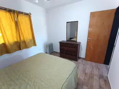 a bedroom with a bed and a dresser and a mirror at Barranca Poceña in Quebrada de los Pozos