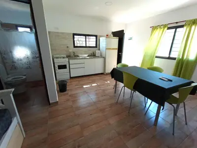 a kitchen and dining room with a table and chairs at Barranca Poceña in Quebrada de los Pozos