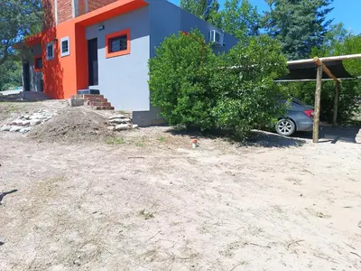 a house with a car parked in front of it at Barranca Poceña in Quebrada de los Pozos