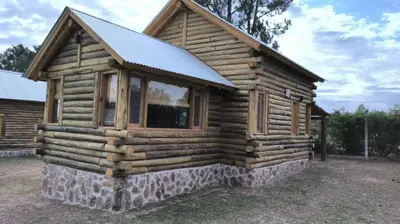 a log cabin with windows on the side of it at Cabañas lipamai in Potrero de Garay