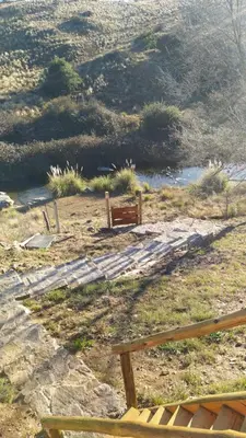 a park bench sitting on top of a hill at Cabañas lipamai in Potrero de Garay