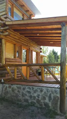 a wooden porch of a log cabin with a deck at Cabañas lipamai in Potrero de Garay