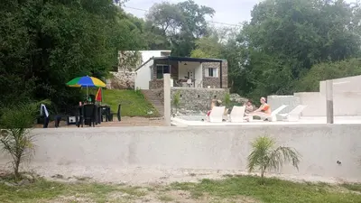 a couple of people sitting in chairs by a wall at CerroMio! in Villa Serranita