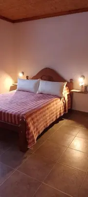 a bedroom with a bed with two pillows on it at CerroMio! in Villa Serranita