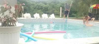 a man and a woman playing in a swimming pool at CerroMio! in Villa Serranita