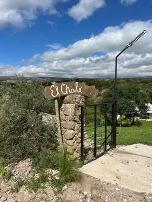a sign for a church on the side of a field at EL CHALÉ casa de campo in Mina Clavero