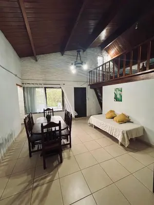 a bedroom with a bed and a table and chairs at EL CHALÉ casa de campo in Mina Clavero